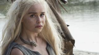 A pensive Daenerys Targaryen (as portrayed by Emilia Clarke) stands by her dragon in HBO's Game of Thrones.