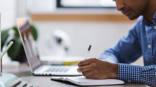 Man researching on laptop