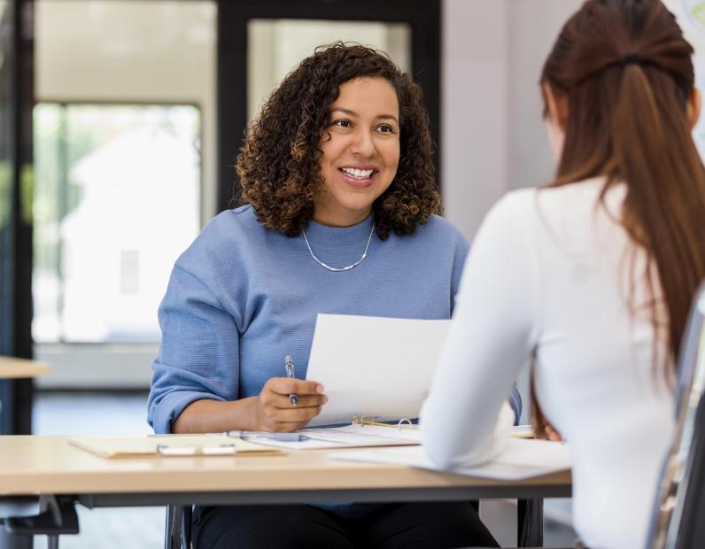 Two people reviewing paperwork